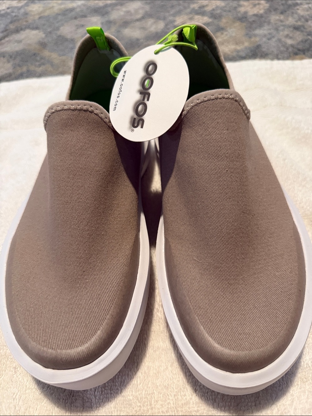 OOFOS Women's Slip-On Sneakers in Taupe with White Sole and Green Pull Tab